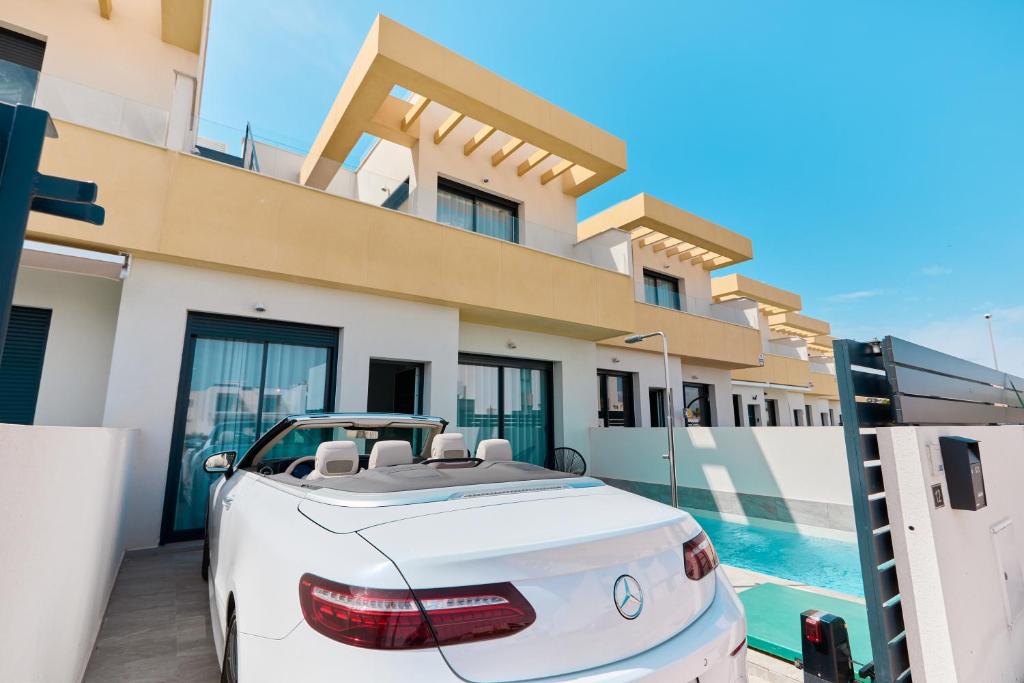 a white car parked in front of a house at Rojales Golf House - by Welcomely in Rojales