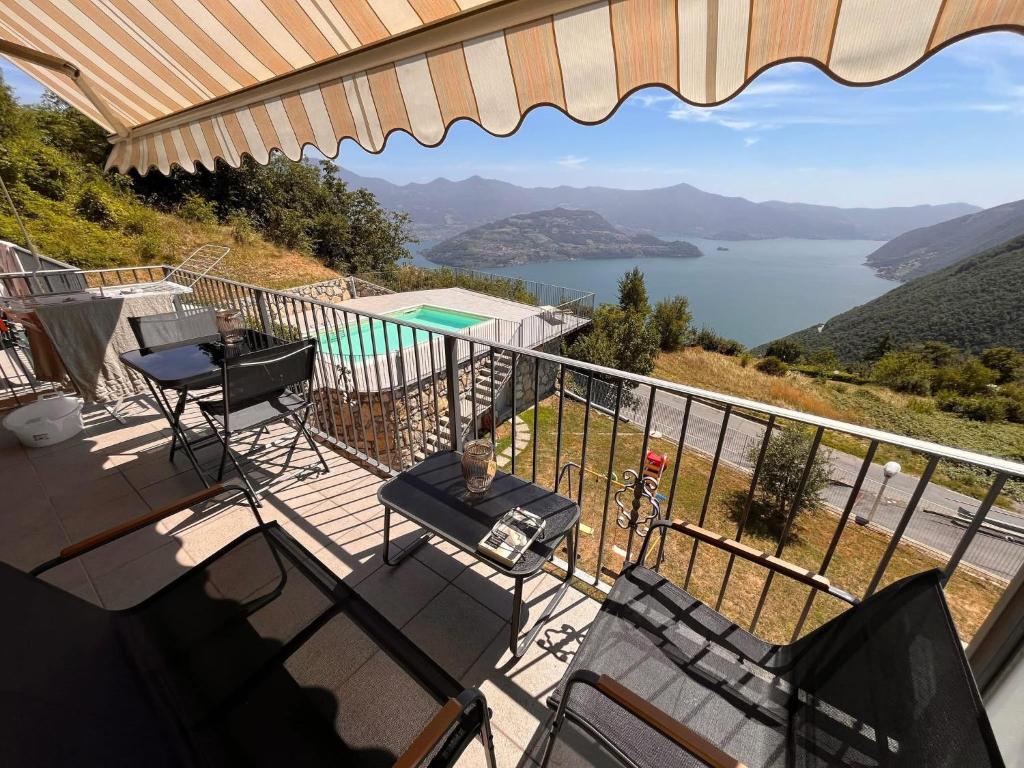 a balcony of a house with a view of a lake at Balconi sul Lago - Stunning Lakeview and Pool in Parzanica