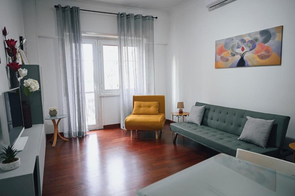 a living room with a green couch and a chair at Room in Rome in Rome
