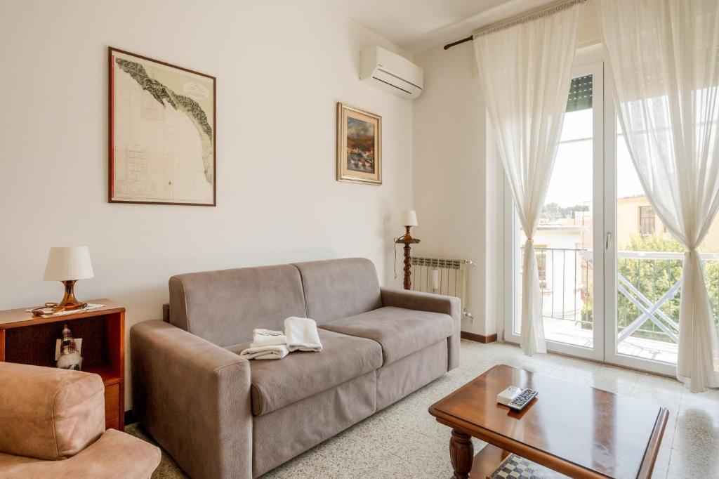 a living room with a couch and a table at GuestHost - A Calanca - Comfy Le Grazie Apartment in Portovenere