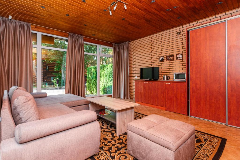 a living room with a couch and a table at Vila Elena in Palanga