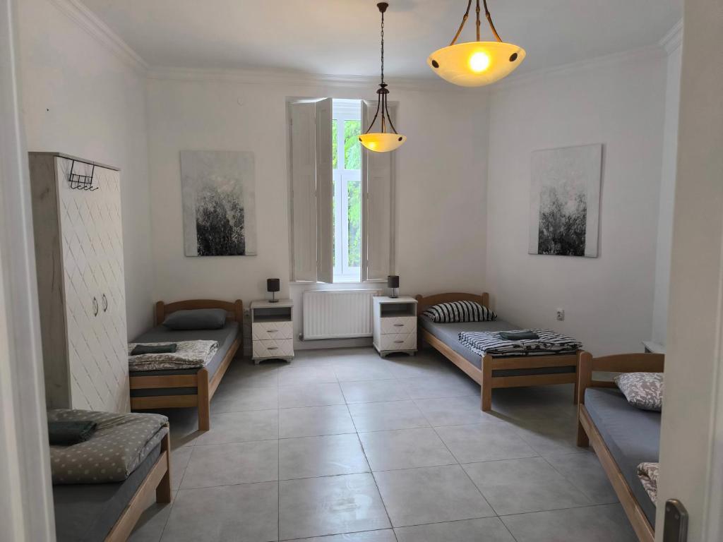 a living room with two beds and a window at Georgi 2 in Subotica