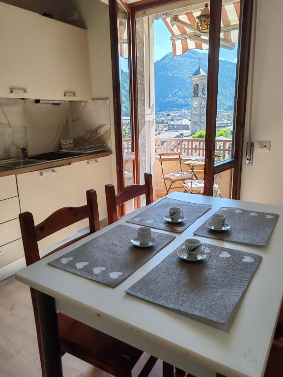 a table with two saucers on it in a kitchen at Casa TERESINA in Ardenno