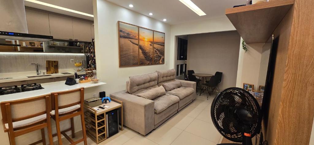 a living room with a couch and a kitchen at Belém COP30 Apartment in Belém