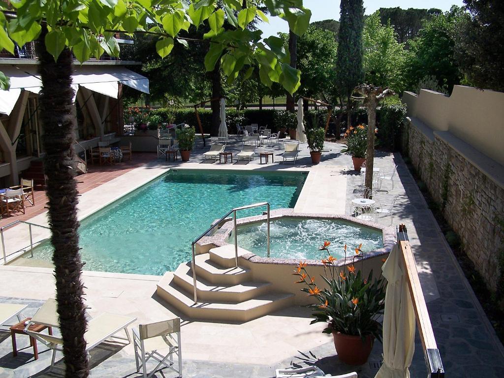 a swimming pool with stairs leading into a resort at Hotel Torretta in Montecatini Terme