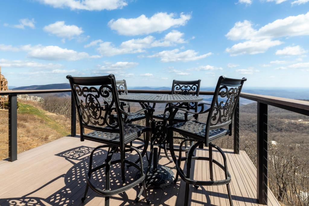 a table and two chairs on a balcony with a view at Ledges 78 with Wintergreen Advantage in Wintergreen