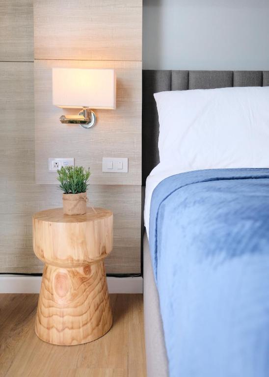 a bedroom with a bed and a table with a plant on it at spacious studio with internet and Netflix in Cebu City