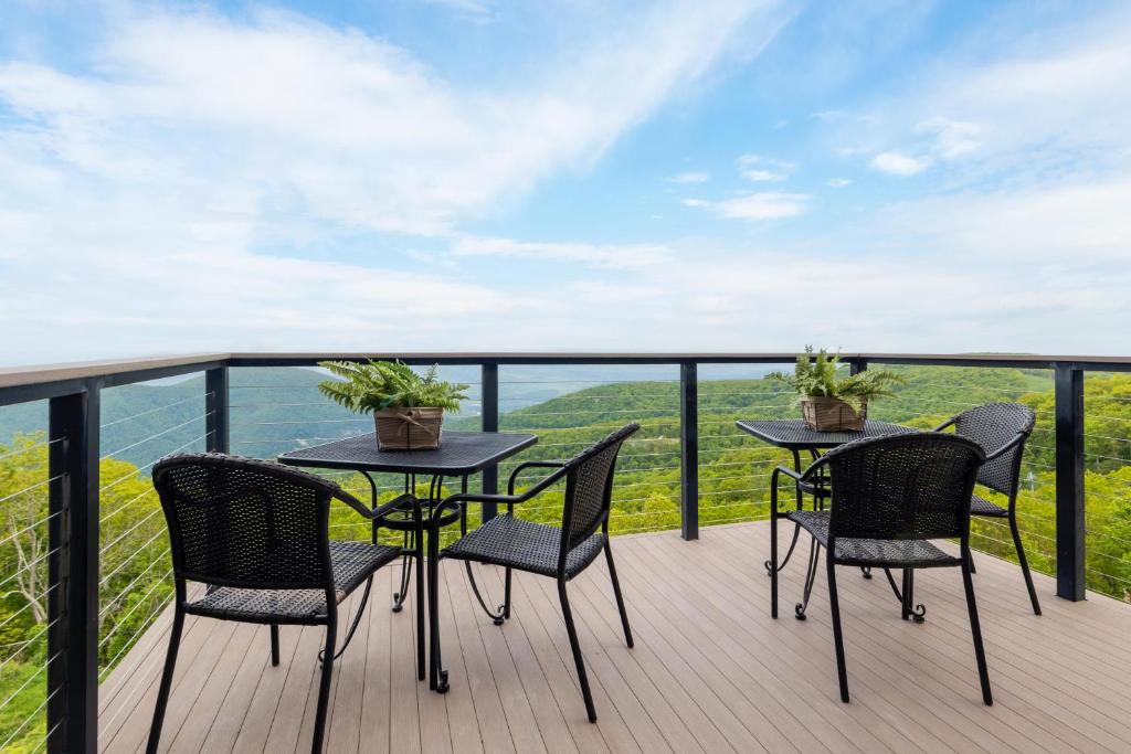 two tables and chairs on a balcony with a view at Ledges 72 with Wintergreen Advantage in Wintergreen