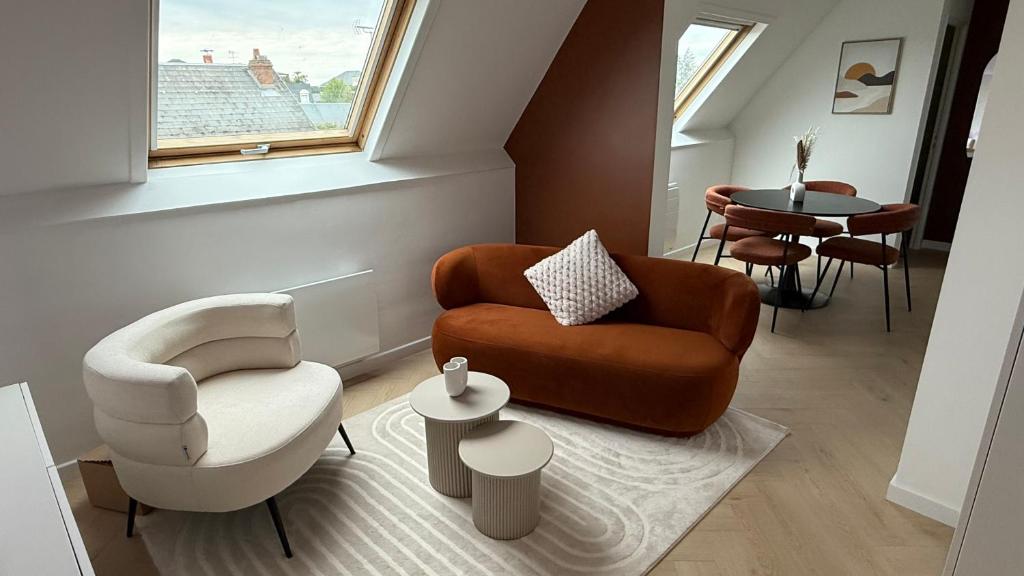 a living room with two chairs and a table at Apartment Orléans in Orléans