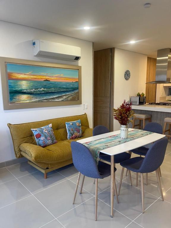 a living room with a yellow couch and a table at Apartamento Santa Marta Reserva del Mar 530 in Gaira