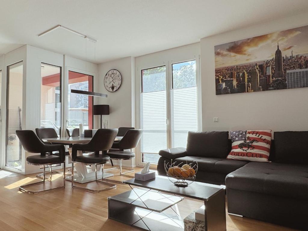 a living room with a couch and a table and chairs at Modern 3-Room Apartment in Stuttgart City Area in Stuttgart