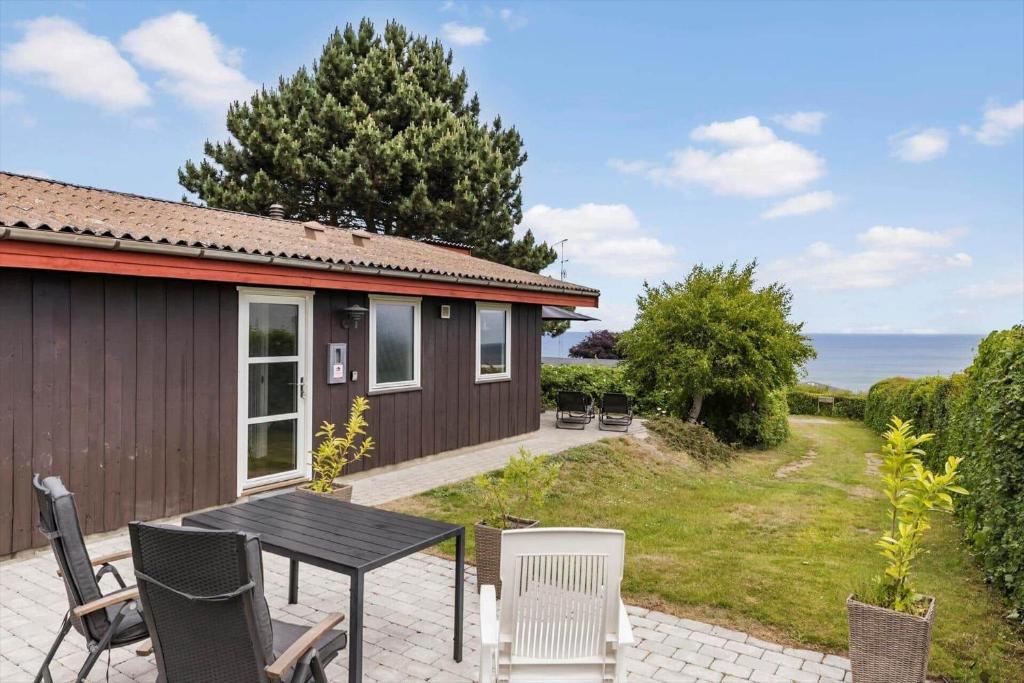 un patio con tavolo e sedie davanti a una casa di 6681-Allinge-Brunekulvej-2-G ad Allinge