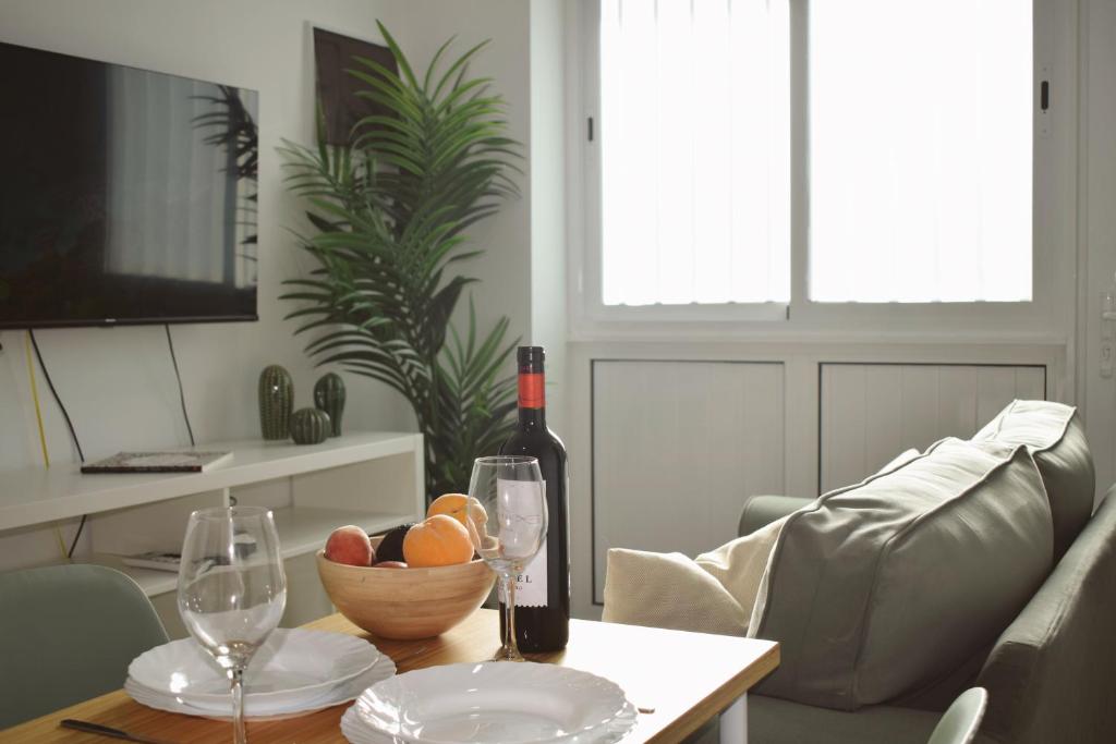 a living room with a table with a bottle of wine and glasses at Brisa del Mar in Tacoronte