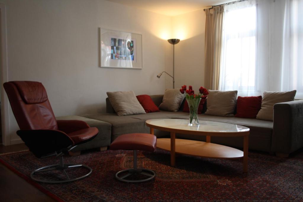 a living room with a couch and a table and chairs at Ferienwohnungen Harz Wernigerode in Wernigerode