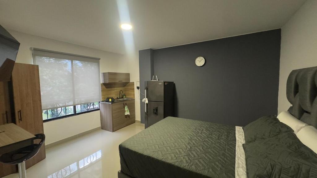 a bedroom with a bed and a black wall at Venezia 308 in Cali