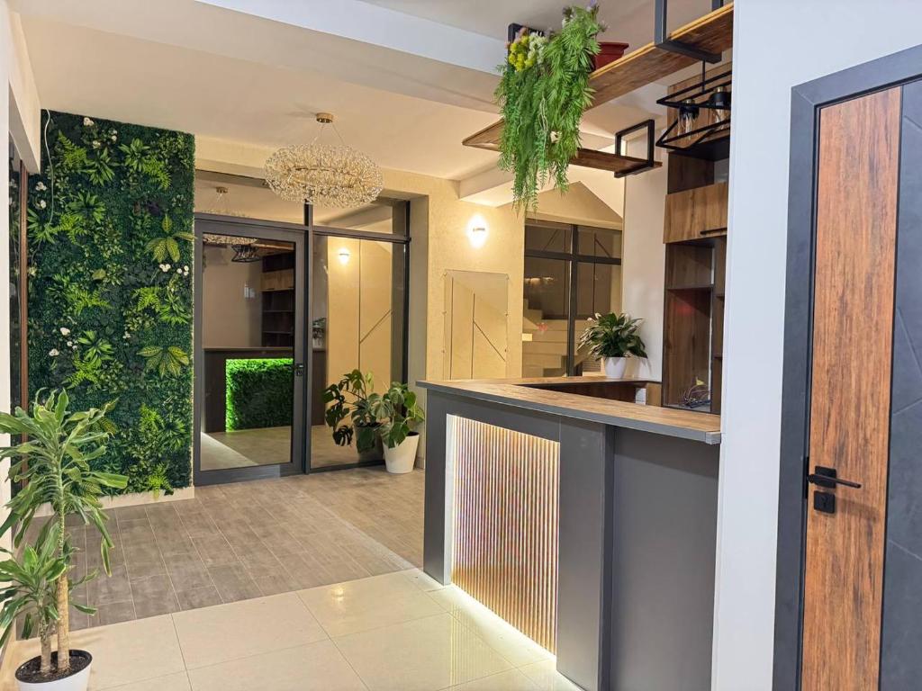 an open lobby with a bar and plants at Generator Tashkent Hostel in Tashkent