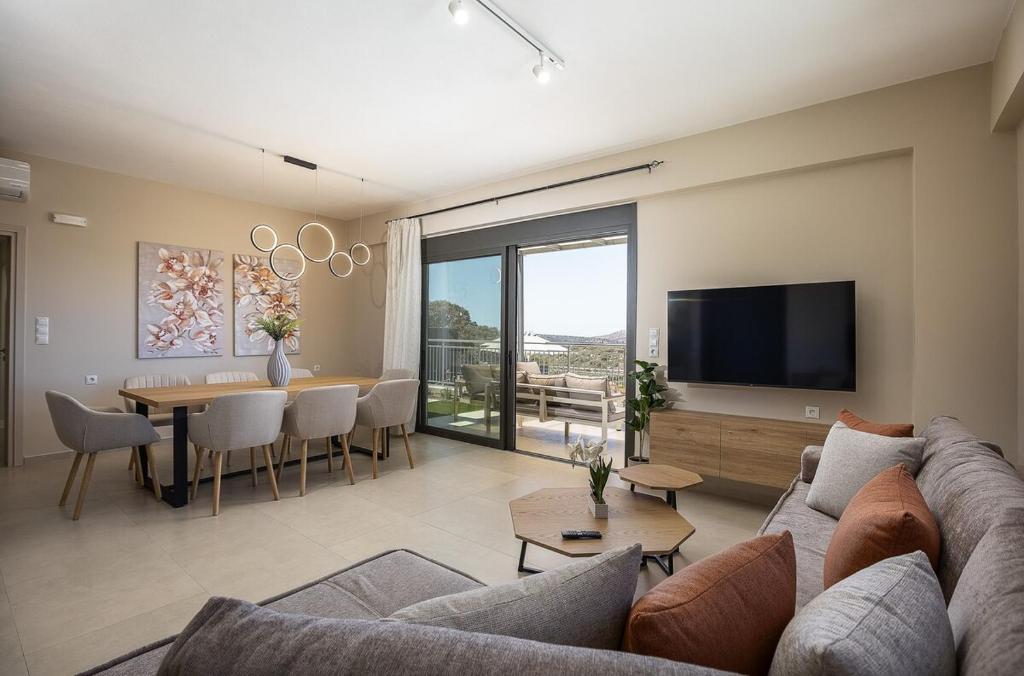 a living room with a couch and a dining room at Emmanouil Private Villa A in Roumelí