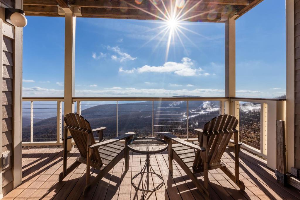 two chairs and a table on a balcony with a view at Overlook 08 with Wintergreen Advantage in Wintergreen