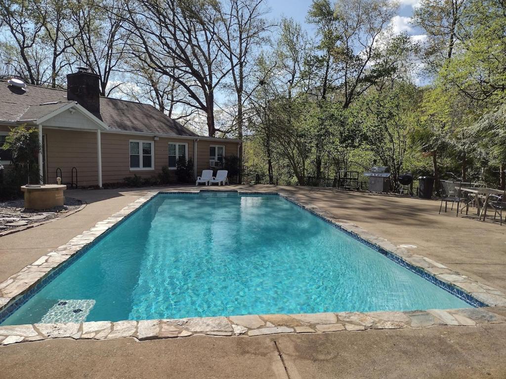a swimming pool in front of a house at Cheerful 3 bedroom home with a sauna and summer pool in Fredericksburg