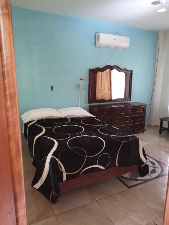 a bedroom with a bed and a dresser and a mirror at Casa rural GuerrApa in San Agustín