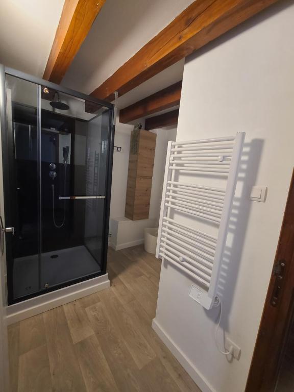 a bathroom with a glass shower in a room at Maison auvergnate entièrement rénovée in Brioude