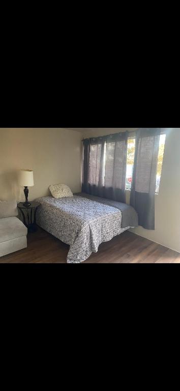 a bedroom with a large bed with a window at Leo's place in Rosarito Beach