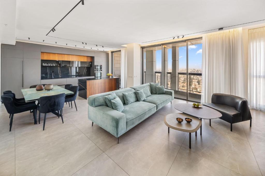 a living room with a couch and a table at JTower - Presidential 3BR Parking with amazing view city center in Jerusalem