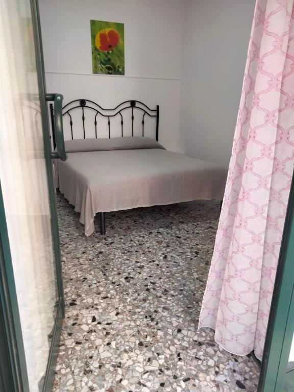 a bedroom with a bed with a pebble floor at Dolce Riposo in Trani