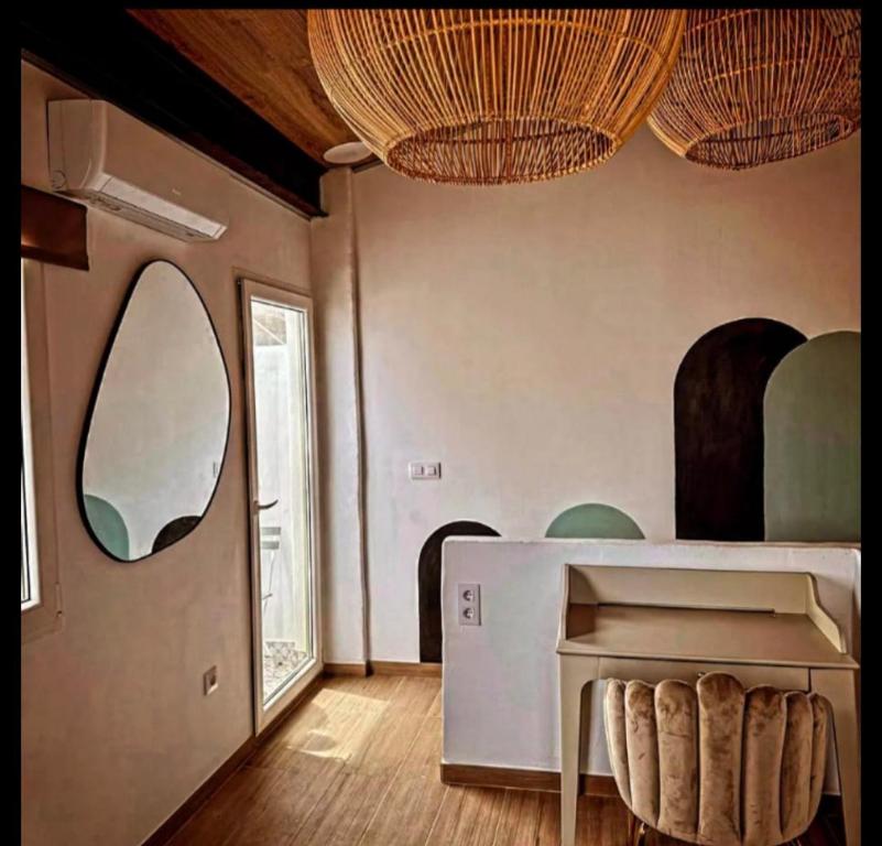a room with a table and a mirror on the wall at Casa griega segunda linea del mar in Oliva