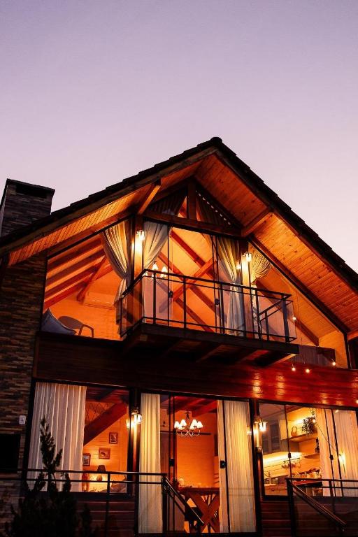 a large house with a balcony on top of it at Chalé cruzeiro do sul, hidromassagem, 2 min Thermas Machadinho-RS #2 in Machadinho