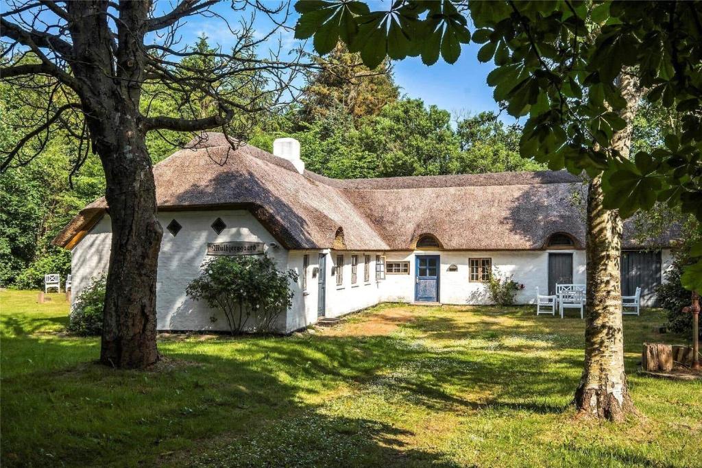 a white house with a shingled roof at OH397-Storvorde-Kystvej-171 in Storvorde