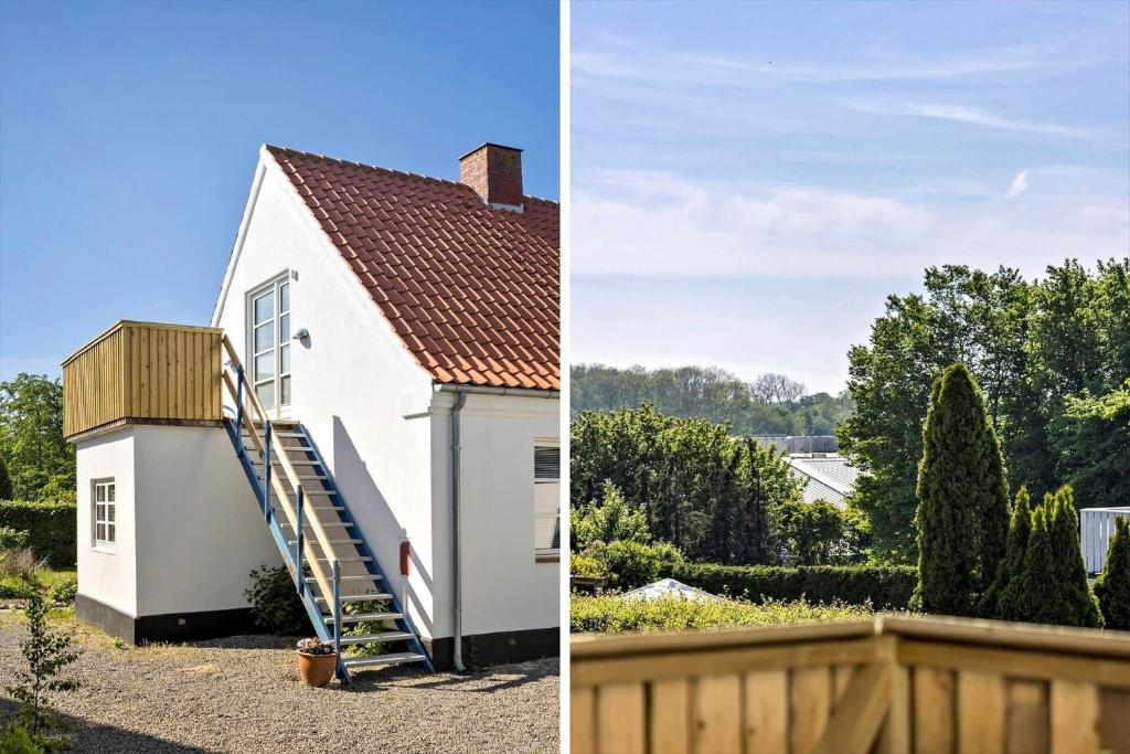 a white house with a ladder on the side at 4790-Ronne-Kanegardsvej-12-1 in Rønne