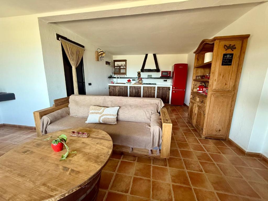 a living room with a couch and a table at Casita Barranco del agua in Yaiza