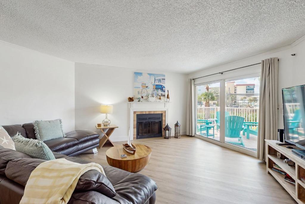 a living room with a couch and a fireplace at Beach Cottage 1104 in Clearwater Beach