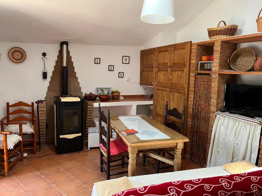 a kitchen with a table and a dining room at Mimbres 28 in El Collado