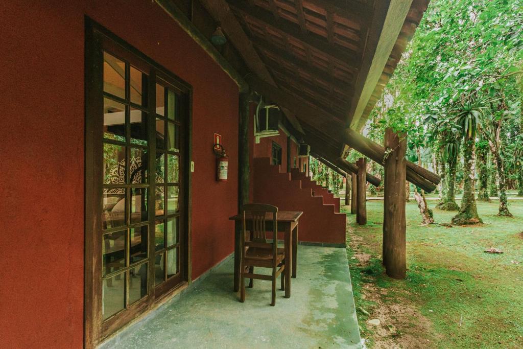 a table and chair sitting outside of a house at Pousada Hakuna Matata in Morretes