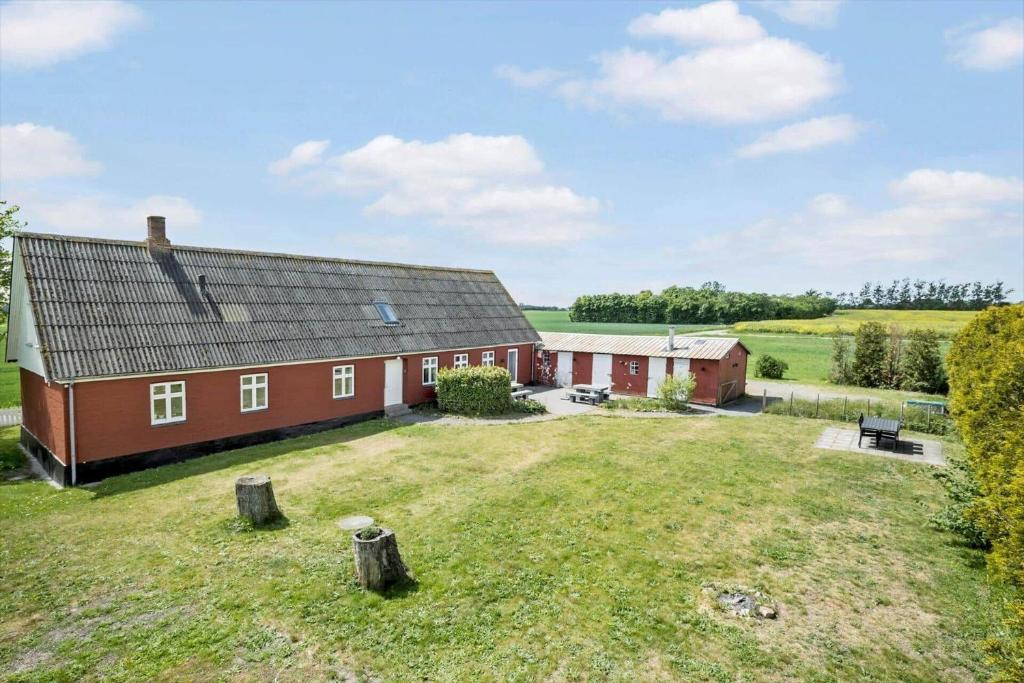 a red barn with a large yard in front of it at 3691-Nexo-Stensebyvejen-32 in Neksø