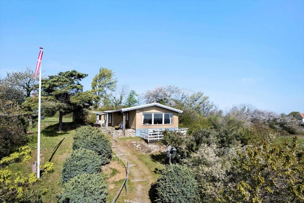 a house on the side of a hill with trees at 6685-Allinge-Tejnvej-24 in Allinge