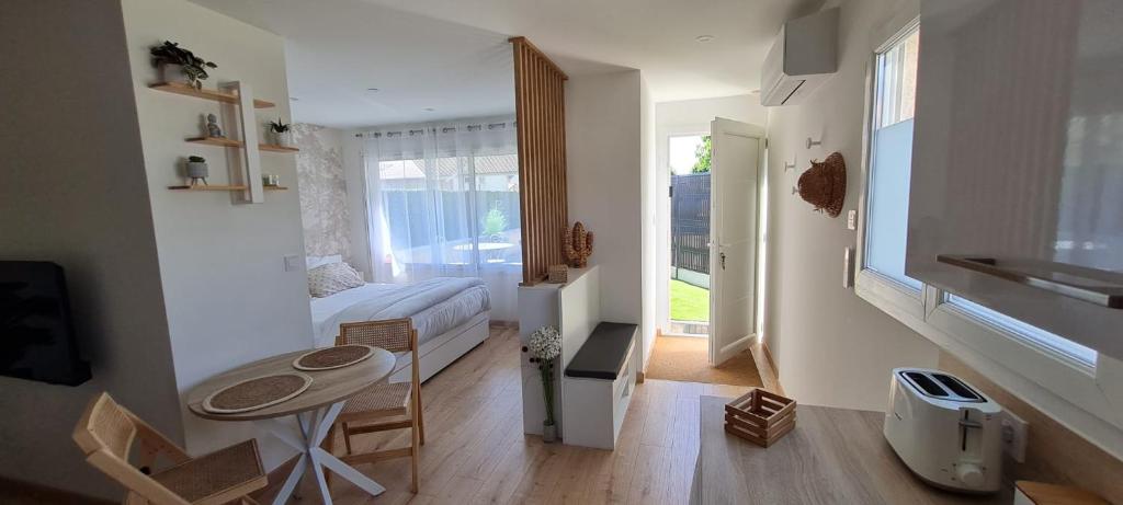 a small room with a bed and a table in it at Le Mulaty Cozy in Tossiat