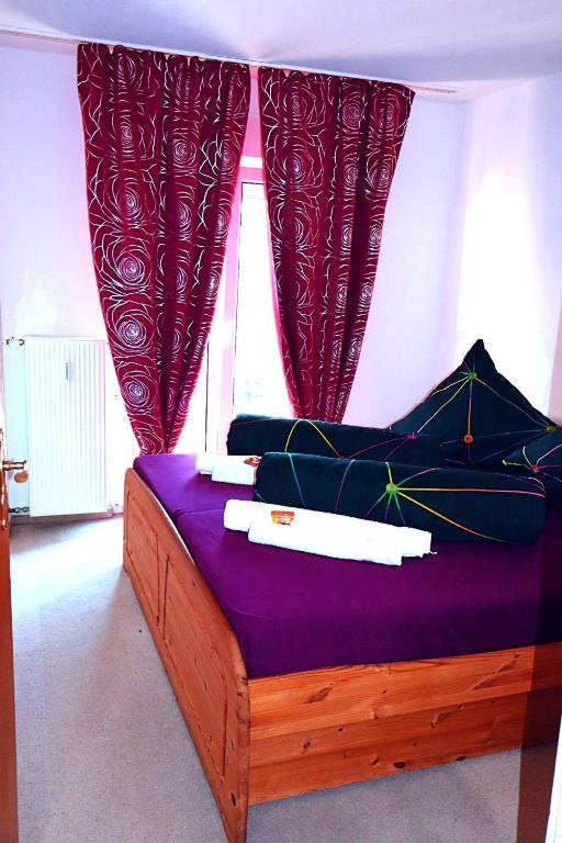 a bedroom with a bed with purple sheets and a window at Holiday Rhein 3 in Boppard