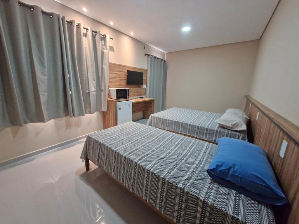 En eller flere senge i et værelse på Apartamento no centro da cidade