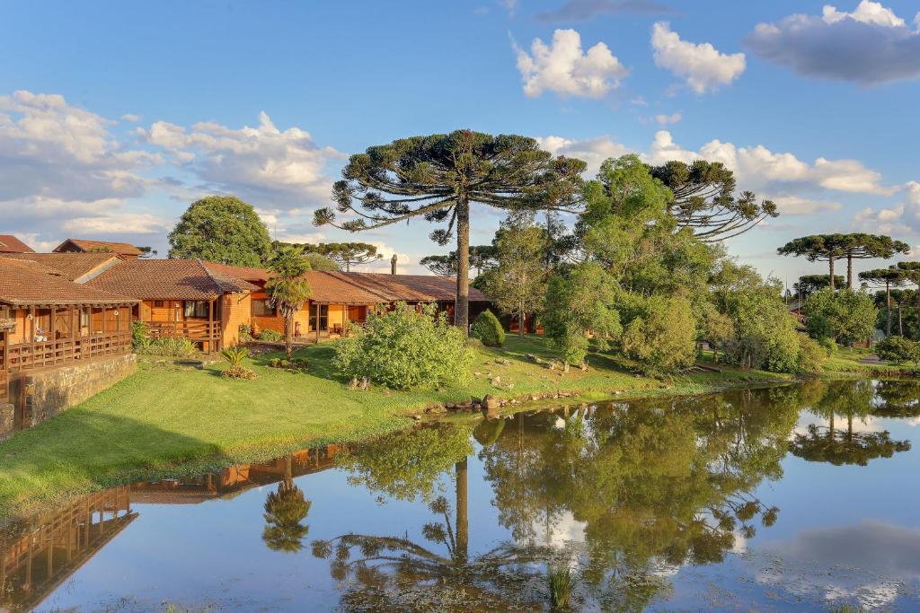 an image of a house next to a river at Boqueirão Hotel Fazenda in Lages