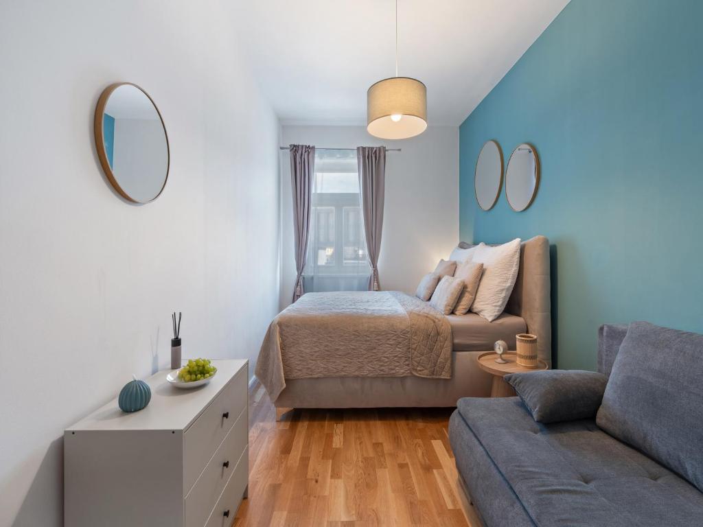 Hotel The Wenceslas Square Rooftop, a small bedroom with a bed and a couch at The Wenceslas Square Rooftop in Prague