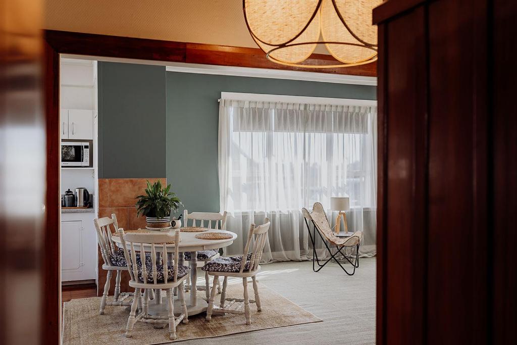 a dining room with a table and chairs at Hokitika Beach Break in Hokitika