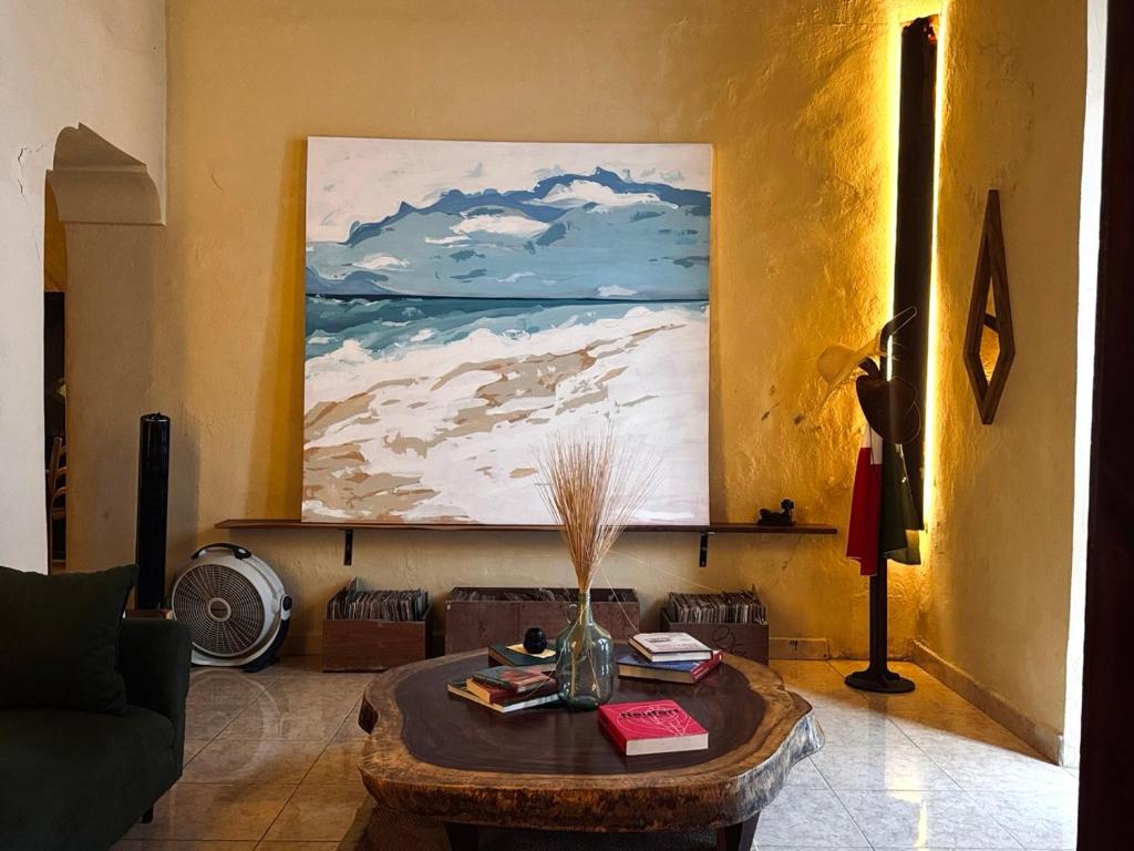 a living room with a coffee table and a painting at Casa Zapata, Campeche in Campeche