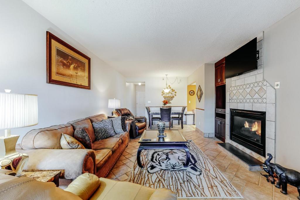 a living room with a couch and a fireplace at River Escape in Pigeon Forge