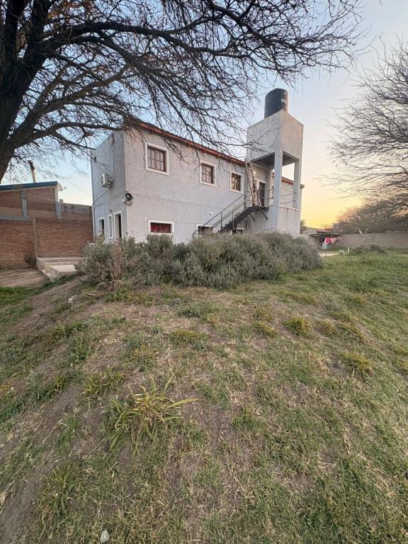 a large white building on a grass field at Solares de Sabatini in Villa del Totoral