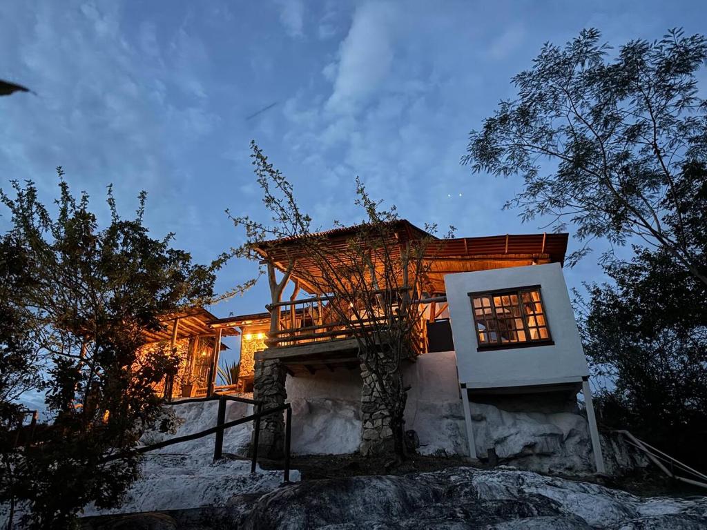 a house sitting on top of a rock at cabaña zamal in Ricaurte