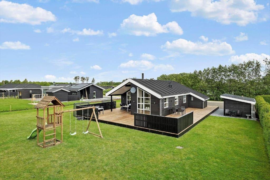 a house with a playground in the yard at OH543-Hadsund-Haslevgarde-eng-16 in Hadsund