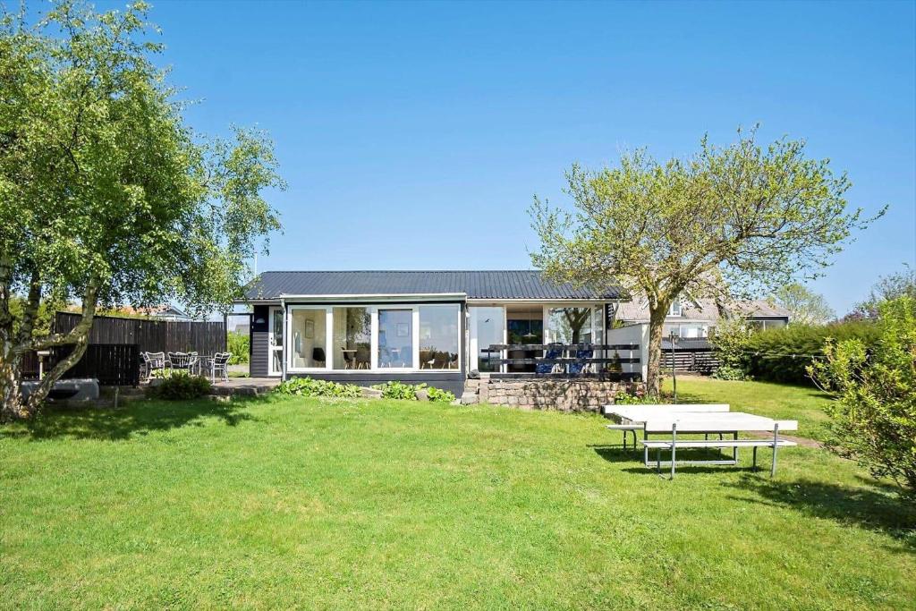 a house with a picnic table in a yard at FY273-Millinge-Buursminde-2 in Millinge